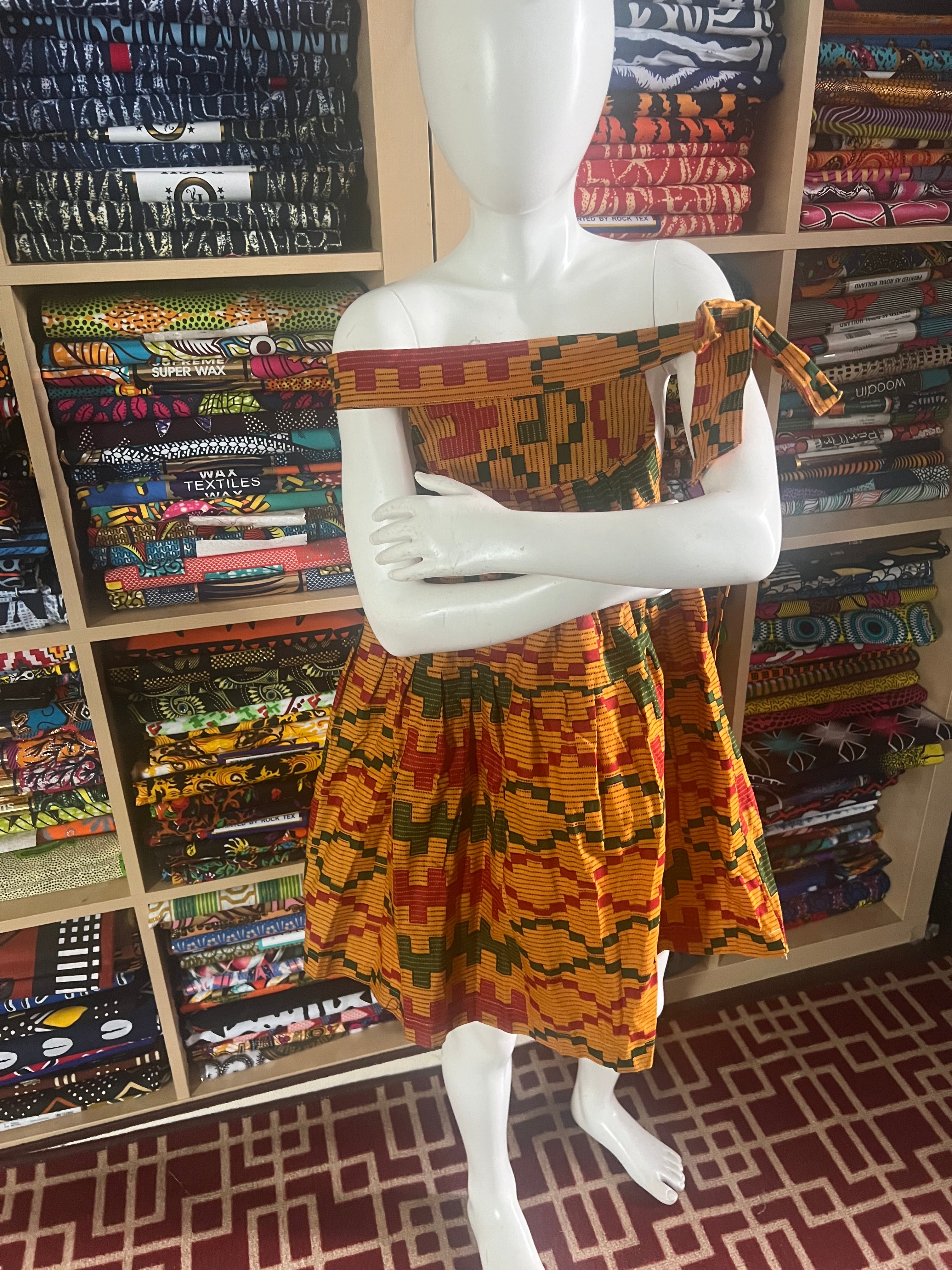 african kaba for kids crafted from vibrant ankara kente fabric ,featuring an open neckline that culminates in a delicate tie at the shoulder