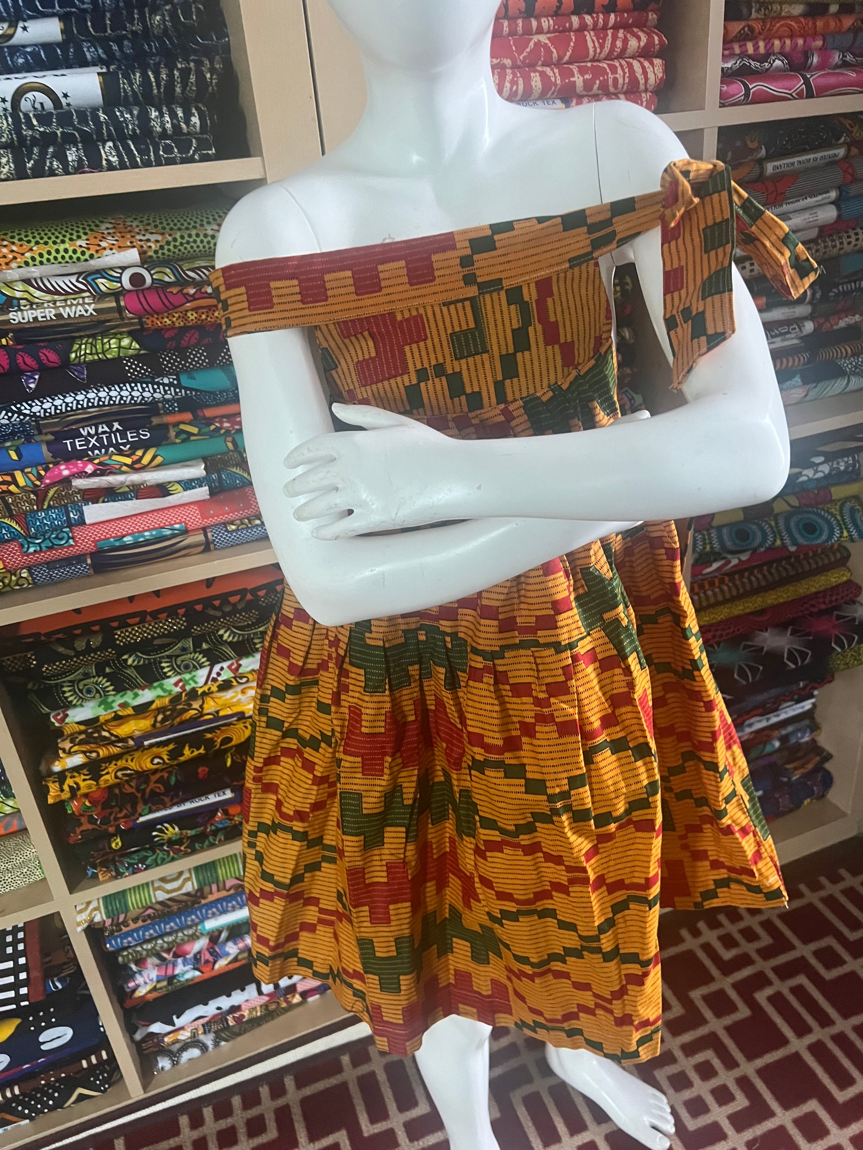african kaba for kids crafted from vibrant ankara kente fabric ,featuring an open neckline that culminates in a delicate tie at the shoulder