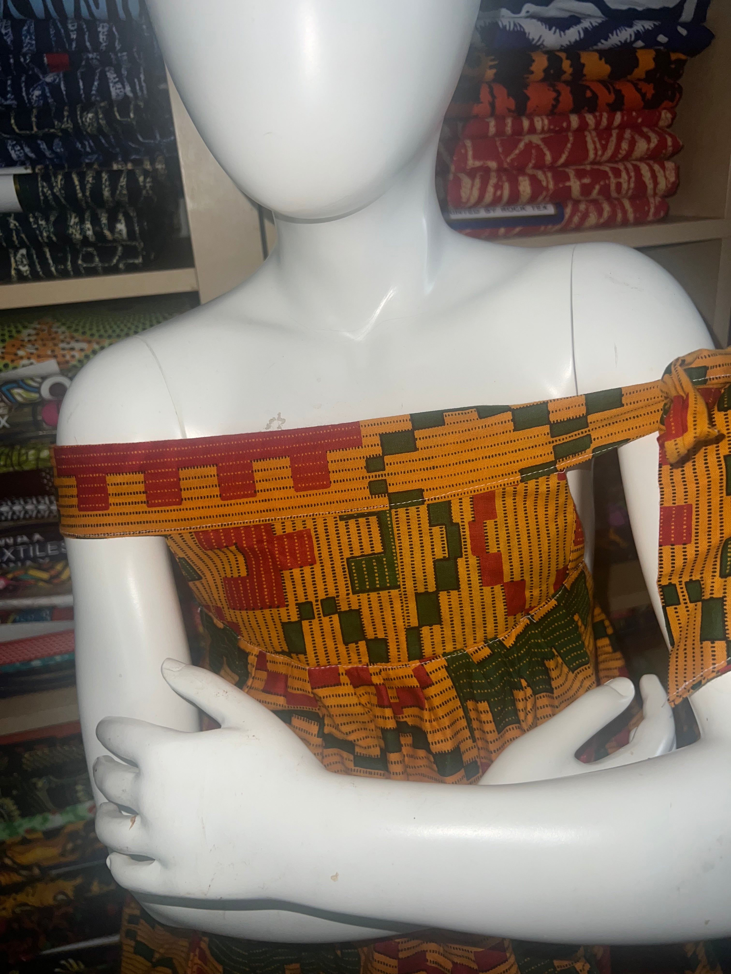 african kaba for kids crafted from vibrant ankara kente fabric ,featuring an open neckline that culminates in a delicate tie at the shoulder