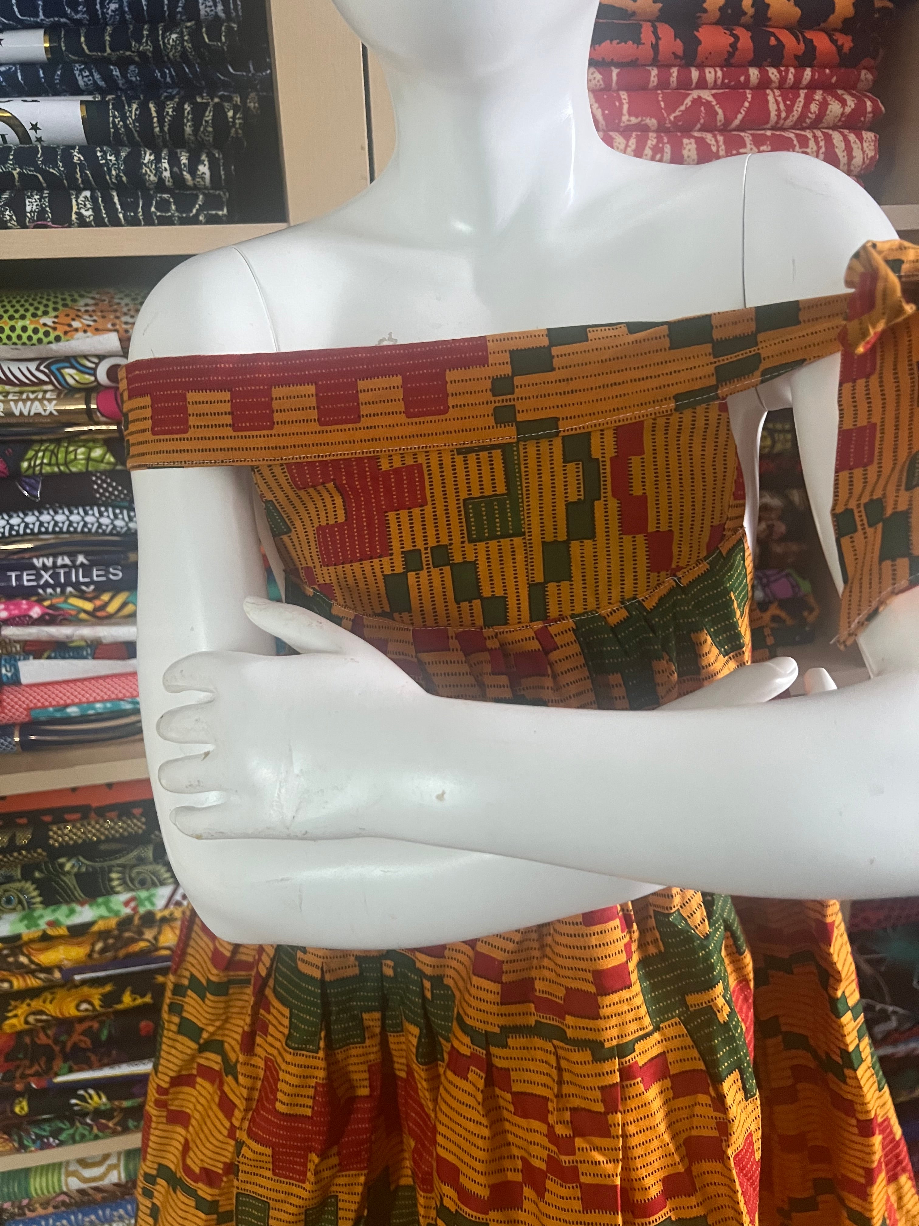 african kaba for kids crafted from vibrant ankara kente fabric ,featuring an open neckline that culminates in a delicate tie at the shoulder