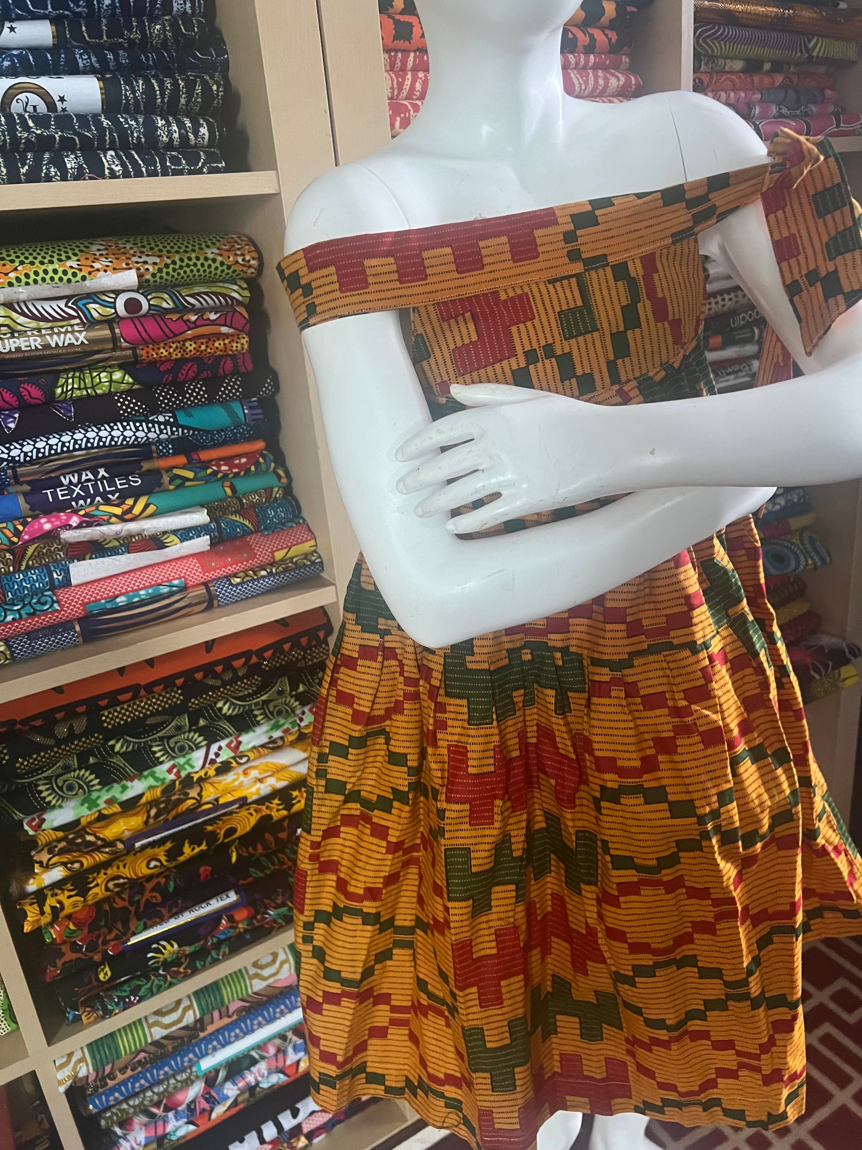 african kaba for kids crafted from vibrant ankara kente fabric ,featuring an open neckline that culminates in a delicate tie at the shoulder