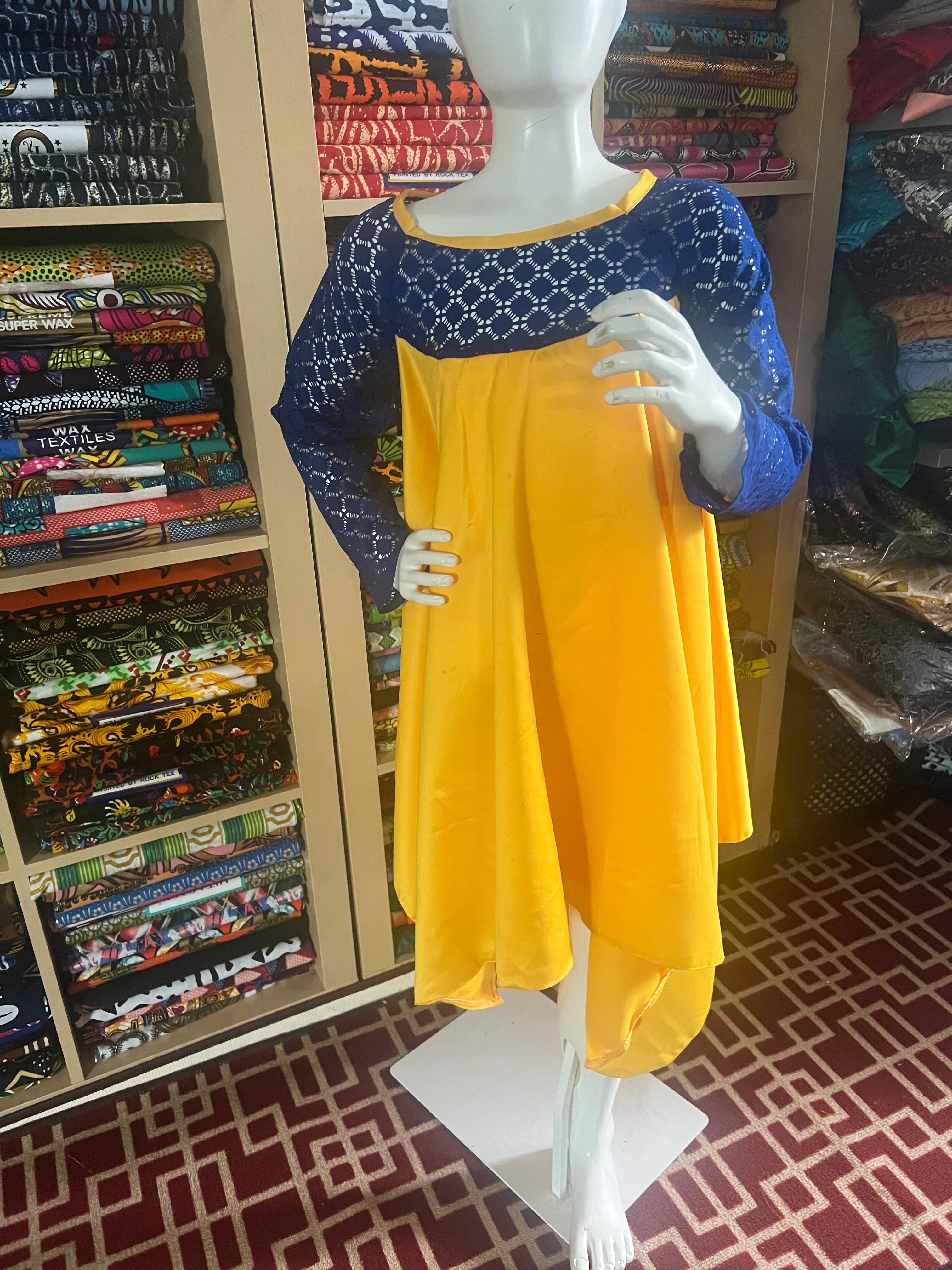 this beautiful Kaba for children is sewn with  yellow  duchess Satine mixed with a blue lace creating a vibrant and eye-catching design.