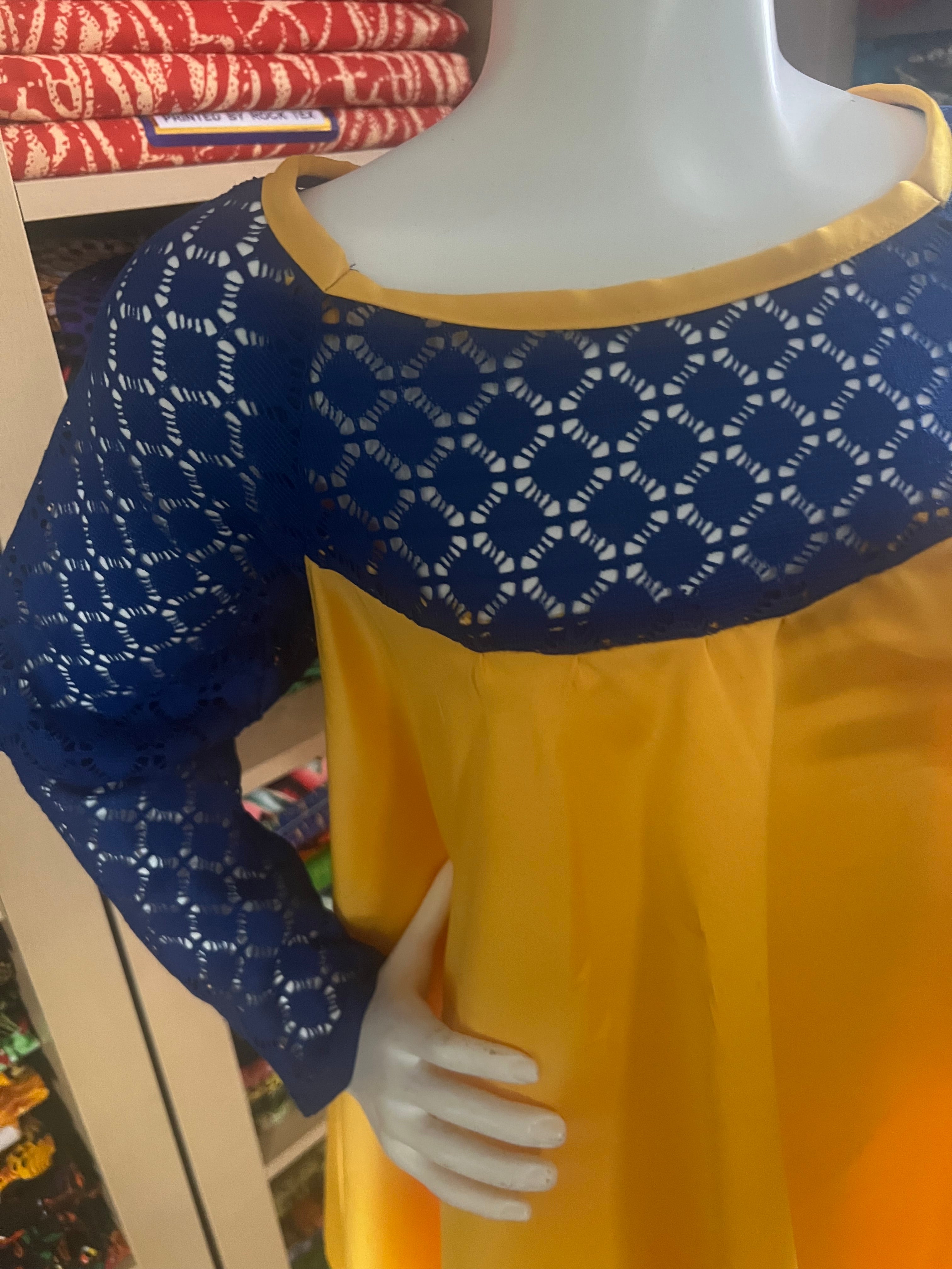 this beautiful Kaba for children is sewn with  yellow  duchess Satine mixed with a blue lace creating a vibrant and eye-catching design.